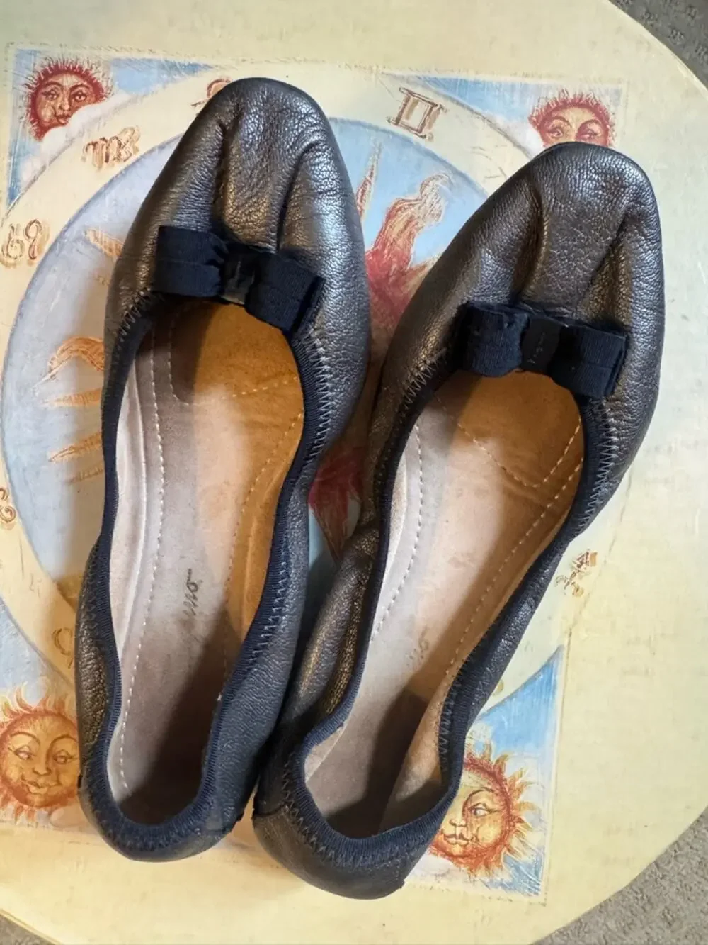 Salvatore Ferragamo Metallic Black Leather Bow Ballet  flats the color is bronze